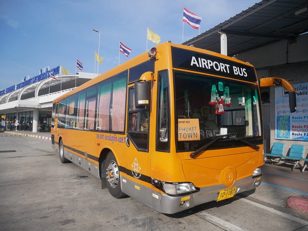 The orange Airport Bus waiting at the terminal curb at Phuket International Airport