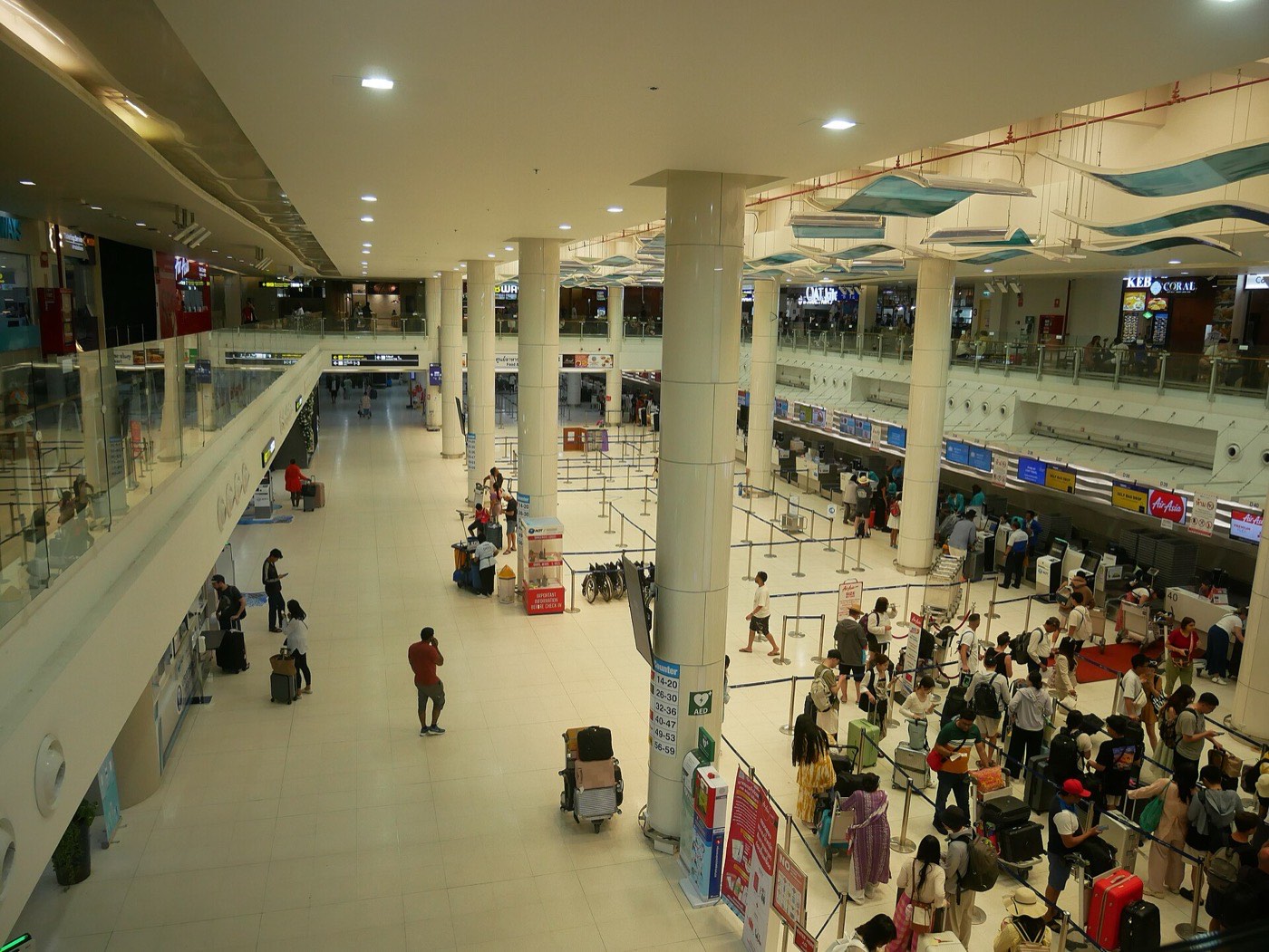 Passengers queueing at check-in counters in the international terminal at Phuket International Airport
